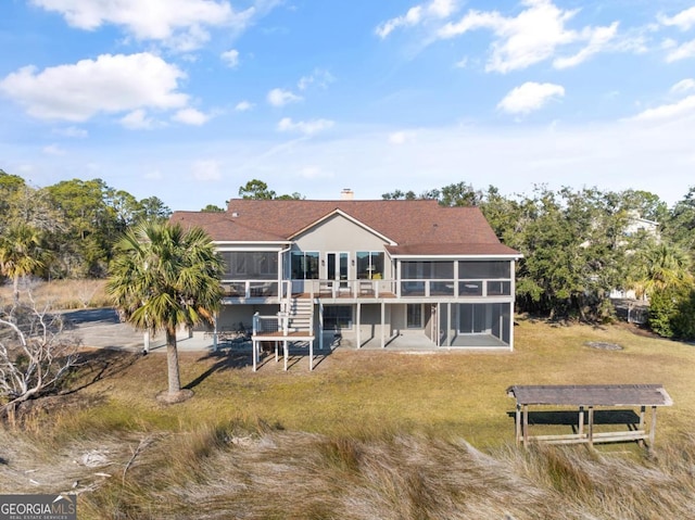 back of property with a sunroom and a patio