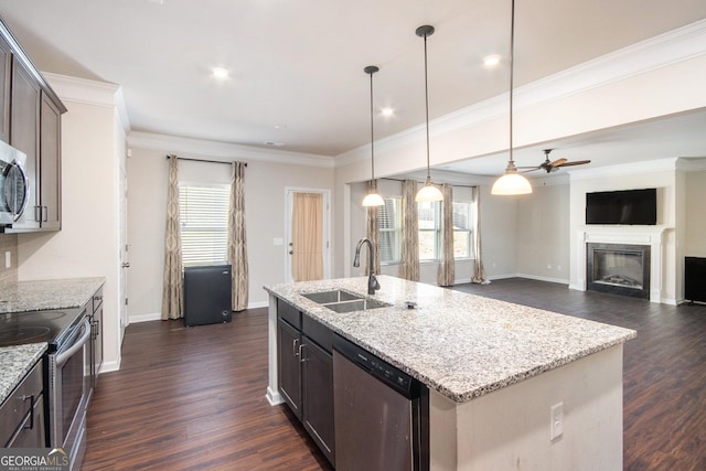 kitchen featuring a center island with sink, stainless steel appliances, ceiling fan, dark brown cabinetry, and sink