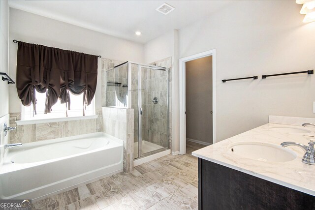 bathroom featuring vanity and separate shower and tub