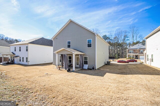 back of house with central AC