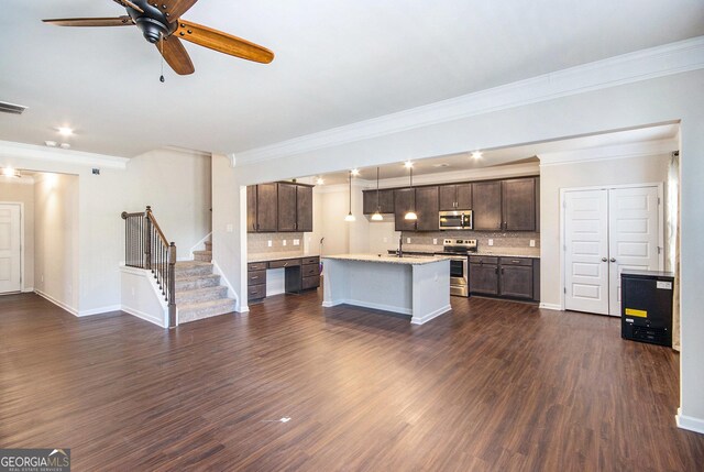 unfurnished living room with ceiling fan, ornamental molding, and dark hardwood / wood-style floors