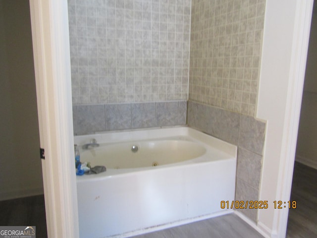 bathroom featuring hardwood / wood-style floors and a tub