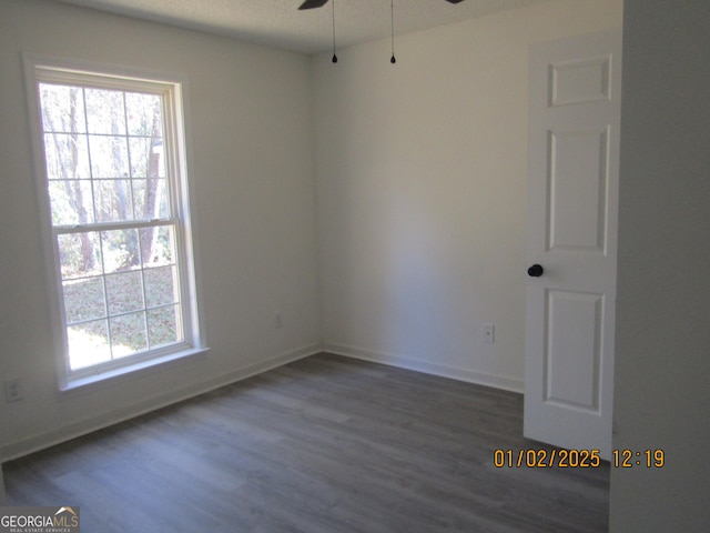 unfurnished room featuring ceiling fan and dark hardwood / wood-style floors