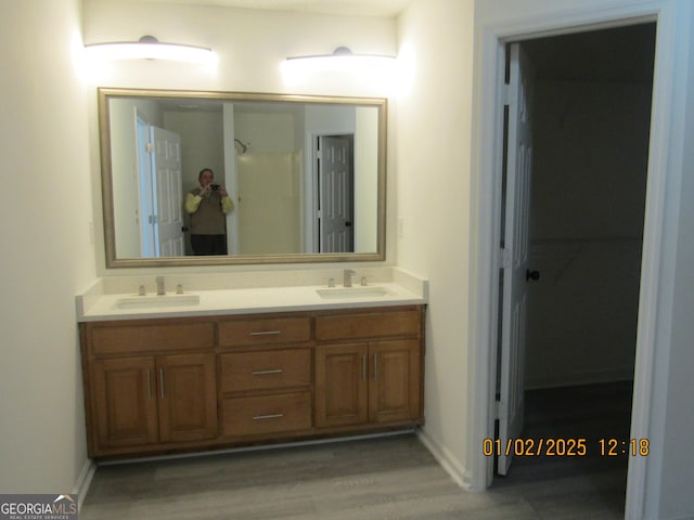 bathroom with hardwood / wood-style floors and vanity