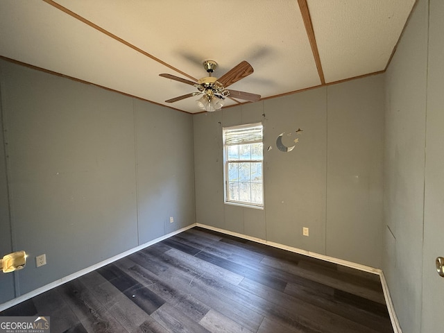 unfurnished room with crown molding, ceiling fan, and dark hardwood / wood-style floors