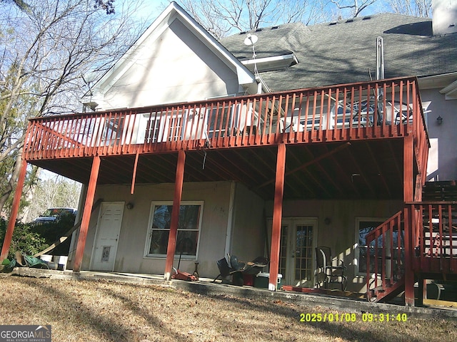 rear view of house featuring a deck