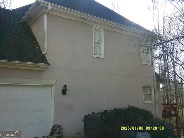 view of side of home featuring a garage