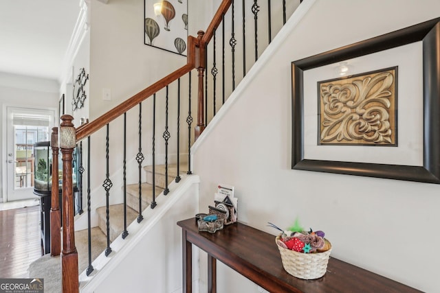 stairway featuring ornamental molding