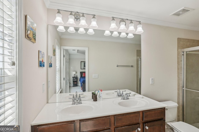 bathroom with a wealth of natural light, crown molding, a shower with door, and toilet