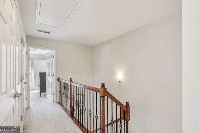 hallway with light colored carpet