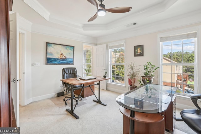 carpeted office with a raised ceiling, ceiling fan, and crown molding