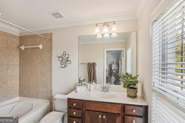 full bathroom featuring vanity, toilet, tiled shower / bath, and crown molding