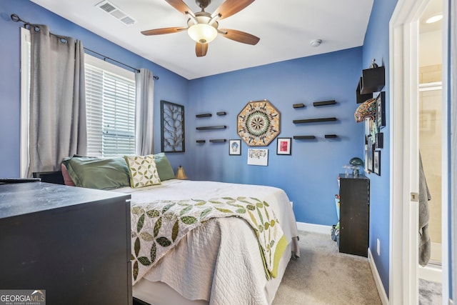 carpeted bedroom with connected bathroom and ceiling fan