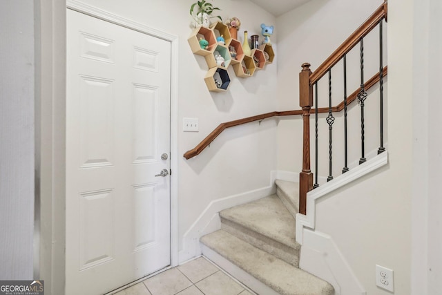 staircase featuring tile patterned flooring