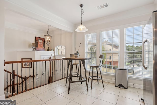 tiled dining area featuring ornamental molding