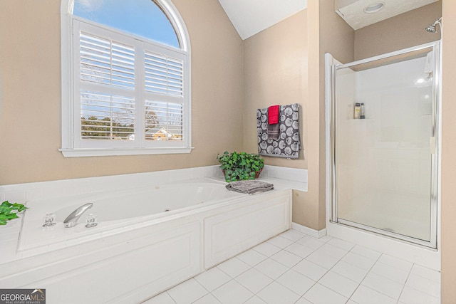 bathroom featuring tile patterned flooring and separate shower and tub