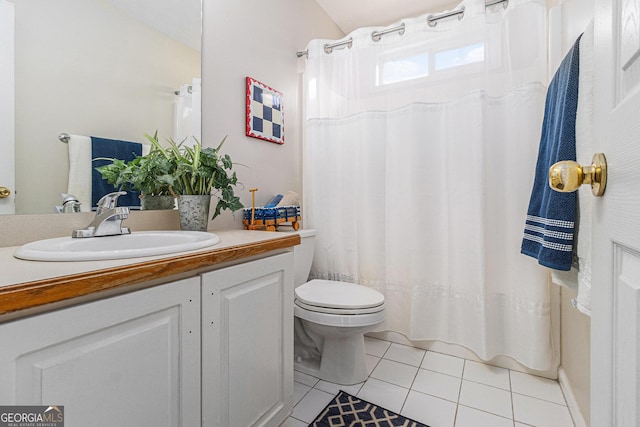 bathroom with tile patterned flooring, vanity, and toilet