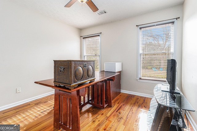 office space with ceiling fan, light hardwood / wood-style flooring, and a textured ceiling