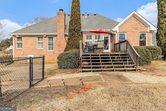 rear view of house featuring a deck