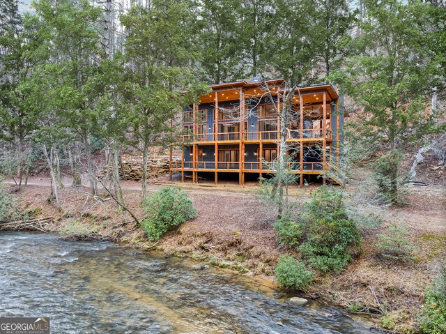 back of house with a water view