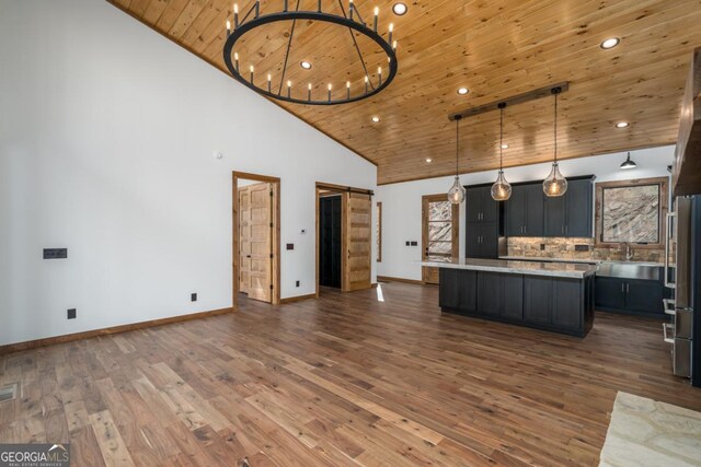 unfurnished bedroom featuring wooden ceiling, dark wood-type flooring, a notable chandelier, and high vaulted ceiling