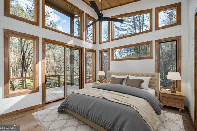 bathroom featuring hardwood / wood-style flooring and plus walk in shower