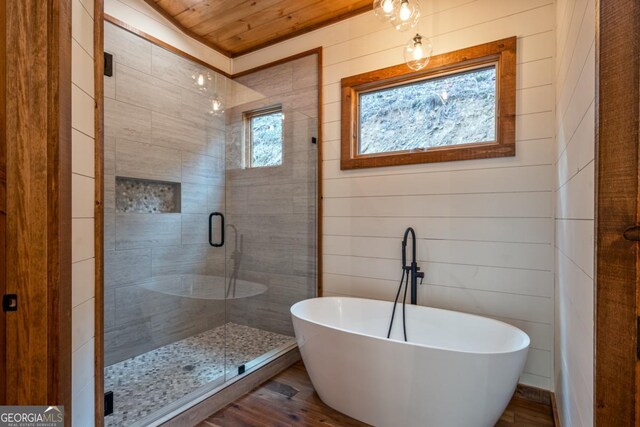 bathroom featuring wood-type flooring, sink, wood ceiling, toilet, and a shower with door