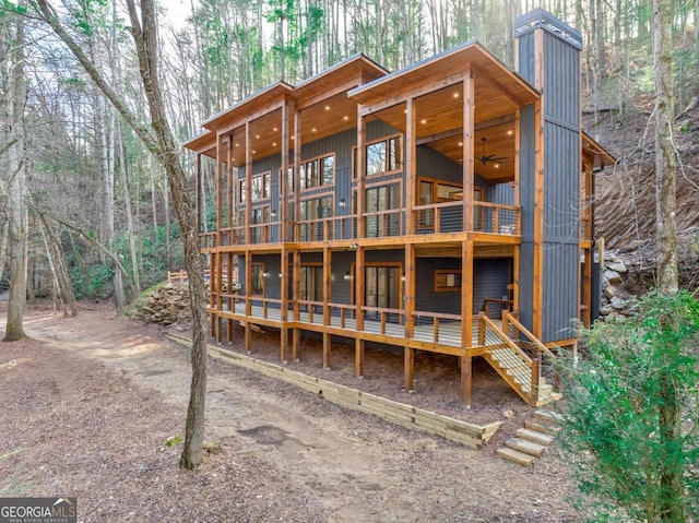 back of property featuring ceiling fan