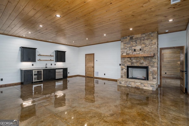 living room with beverage cooler, sink, a stone fireplace, and wooden ceiling