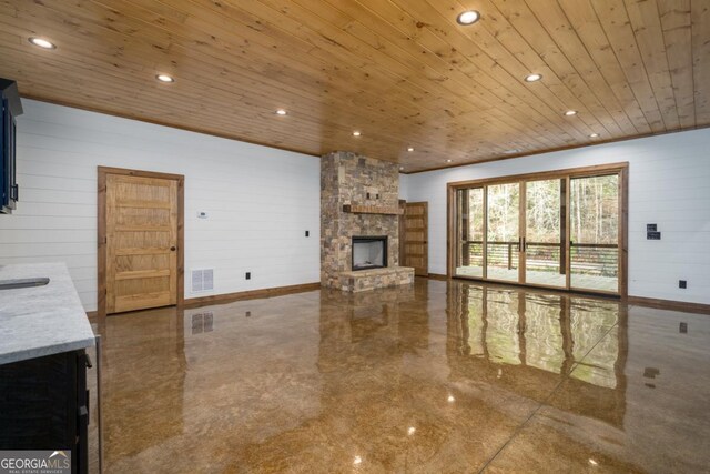 entrance foyer featuring sink, wood ceiling, wooden walls, and ceiling fan