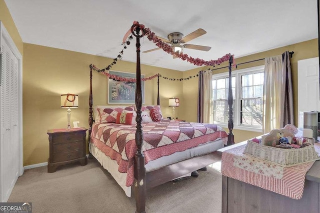 carpeted bedroom featuring ceiling fan and a closet