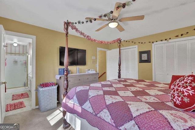 carpeted bedroom with two closets and ceiling fan