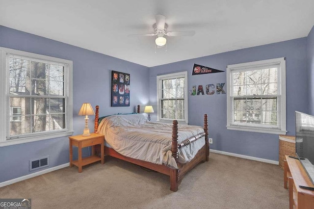 bedroom featuring ceiling fan and carpet