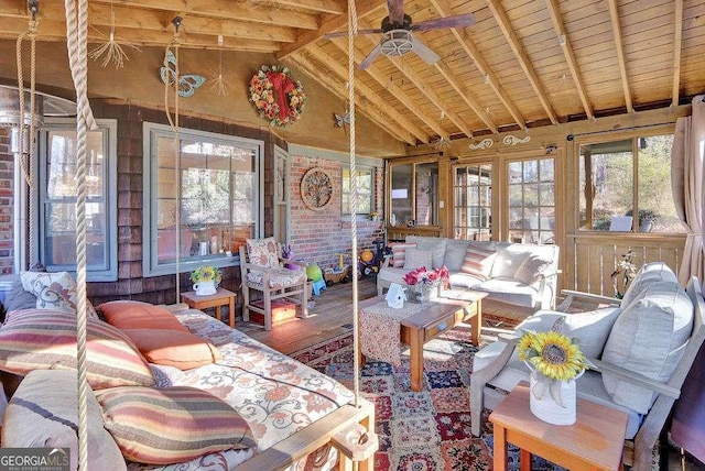 sunroom / solarium with vaulted ceiling with beams, ceiling fan, and wood ceiling