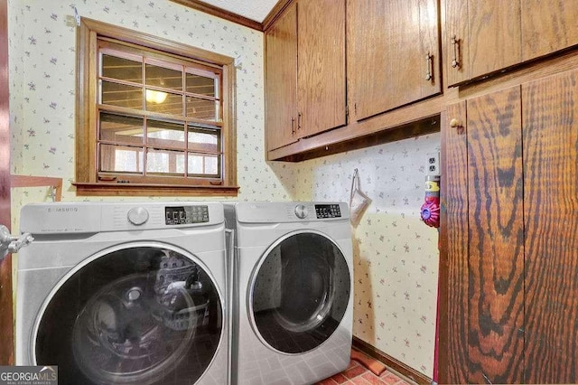 laundry room with cabinets, separate washer and dryer, and crown molding