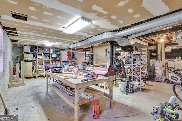 basement featuring a workshop area and gas water heater