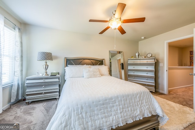 bedroom featuring carpet flooring, ceiling fan, and multiple windows