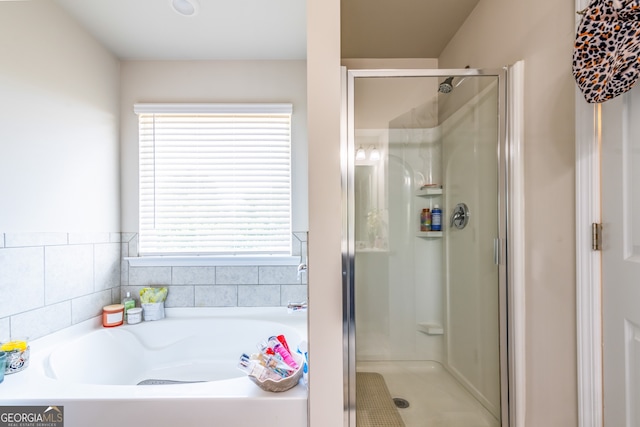 bathroom with shower with separate bathtub