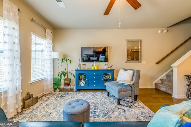 living room with ceiling fan and dark hardwood / wood-style floors