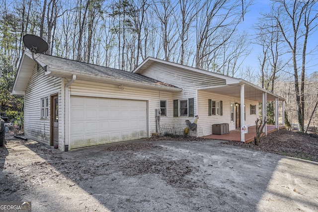 single story home featuring a porch and a garage