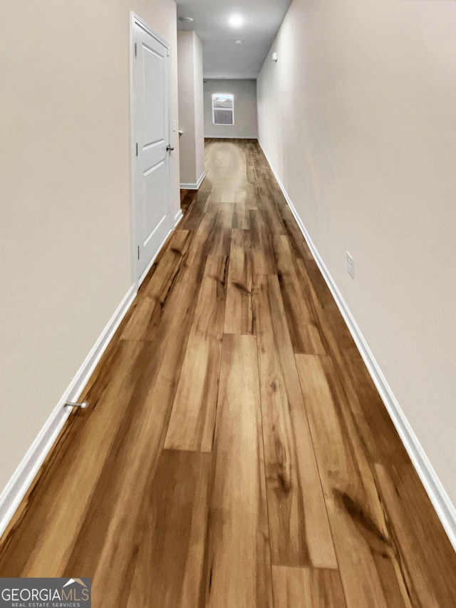 hallway featuring wood-type flooring