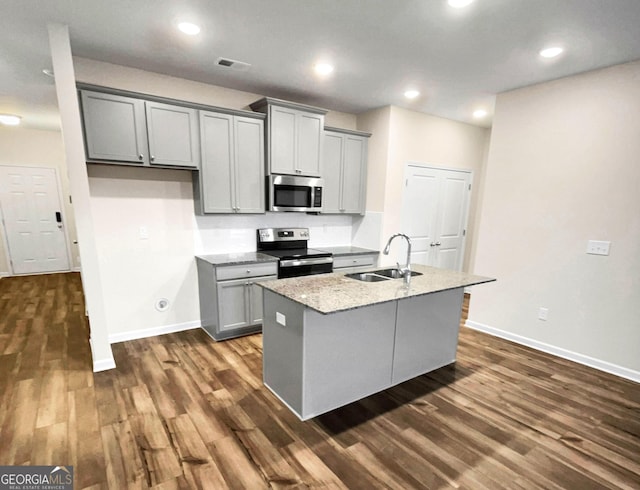 kitchen with gray cabinets, sink, an island with sink, and appliances with stainless steel finishes