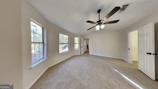 carpeted empty room featuring ceiling fan and vaulted ceiling