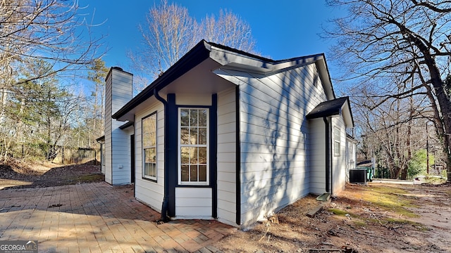 view of home's exterior with cooling unit and a patio