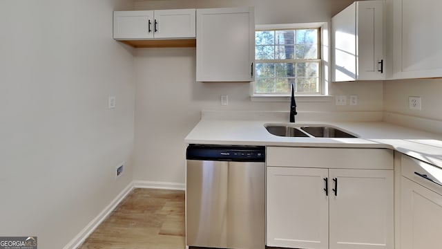 kitchen with white cabinetry, dishwasher, and sink