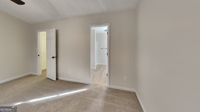 unfurnished bedroom with ceiling fan and light carpet