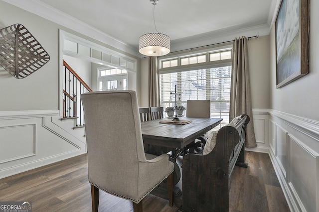 dining area featuring dark wood-type flooring and ornamental molding