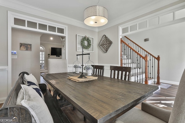 dining room featuring dark wood-type flooring and crown molding