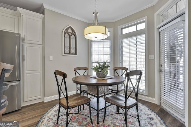 dining area with dark hardwood / wood-style flooring and crown molding