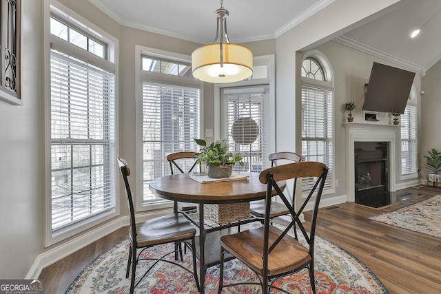 dining space featuring crown molding and dark hardwood / wood-style floors